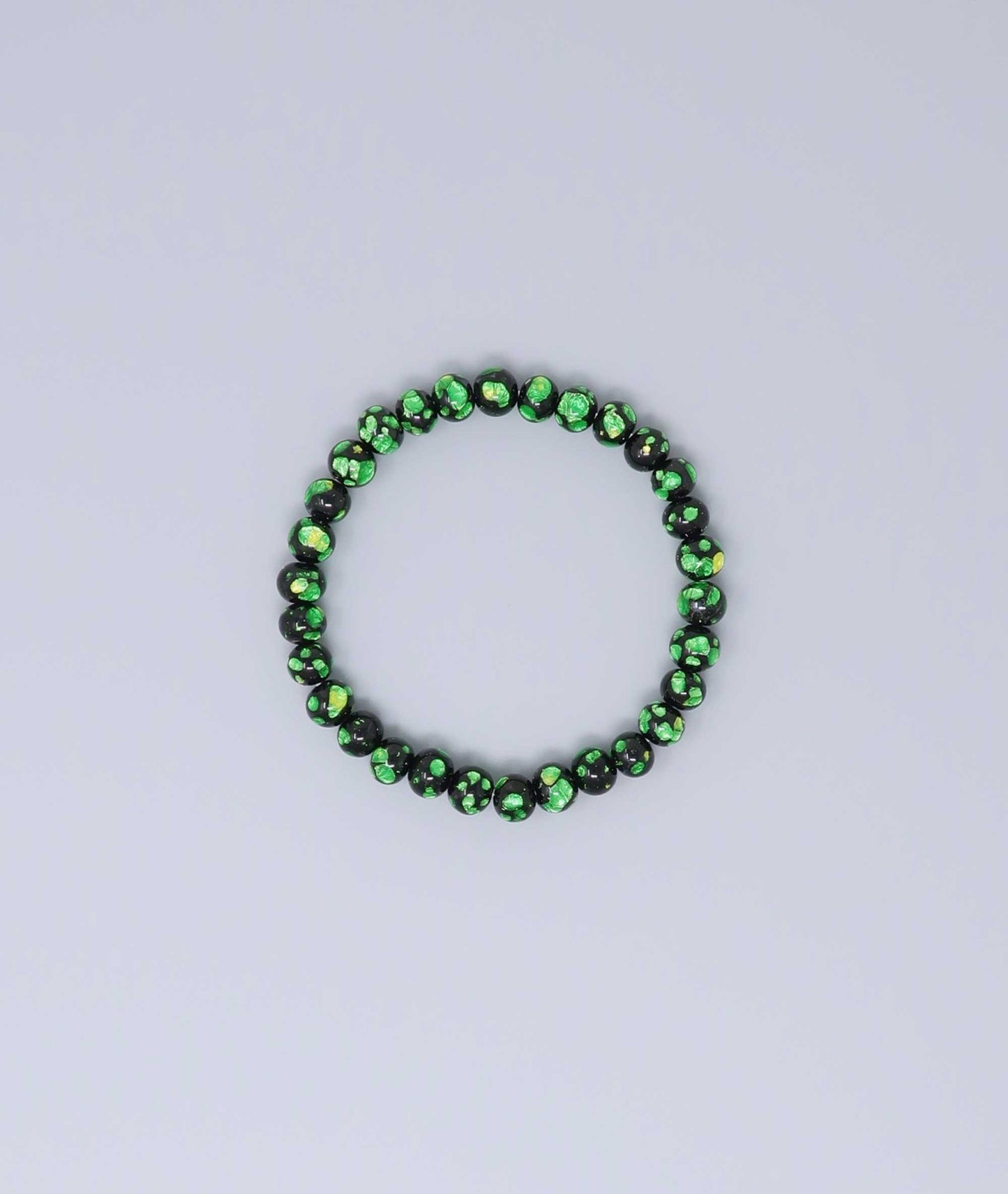 Elegant green Ryukyu fluorite bracelet with shimmering green accents on a jet-black base. Handmade by artisans, combining mystique and luxury. Handcrafted in Japan Kanbe Juzu, ideal for amulet, yoga, meditation, prayer, or gifting.