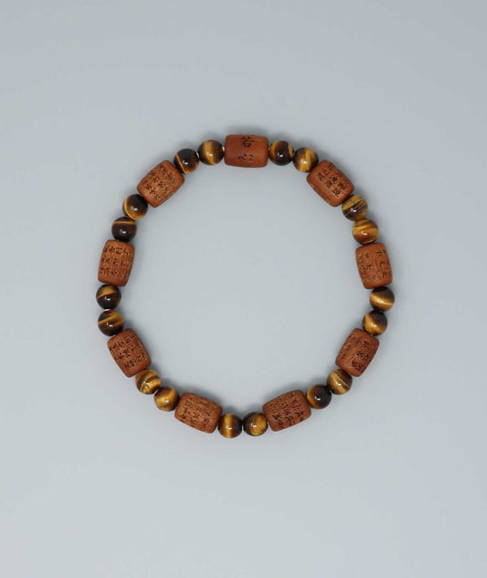Sandalwood bracelet engraved with the Heart Sutra and accented with a Tiger’s Eye bead—handcrafted for spiritual protection and harmony. Handcrafted in Kyoto Japan Kanbe Juzu, ideal for amulet, yoga, meditation, prayer, or gifting.