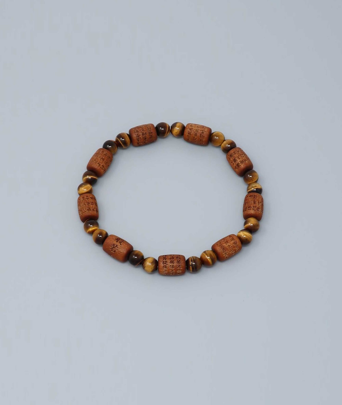 Sandalwood bracelet engraved with the Heart Sutra and accented with a Tiger’s Eye bead—handcrafted for spiritual protection and harmony. Handcrafted in Kyoto Japan Kanbe Juzu, ideal for amulet, yoga, meditation, prayer, or gifting.