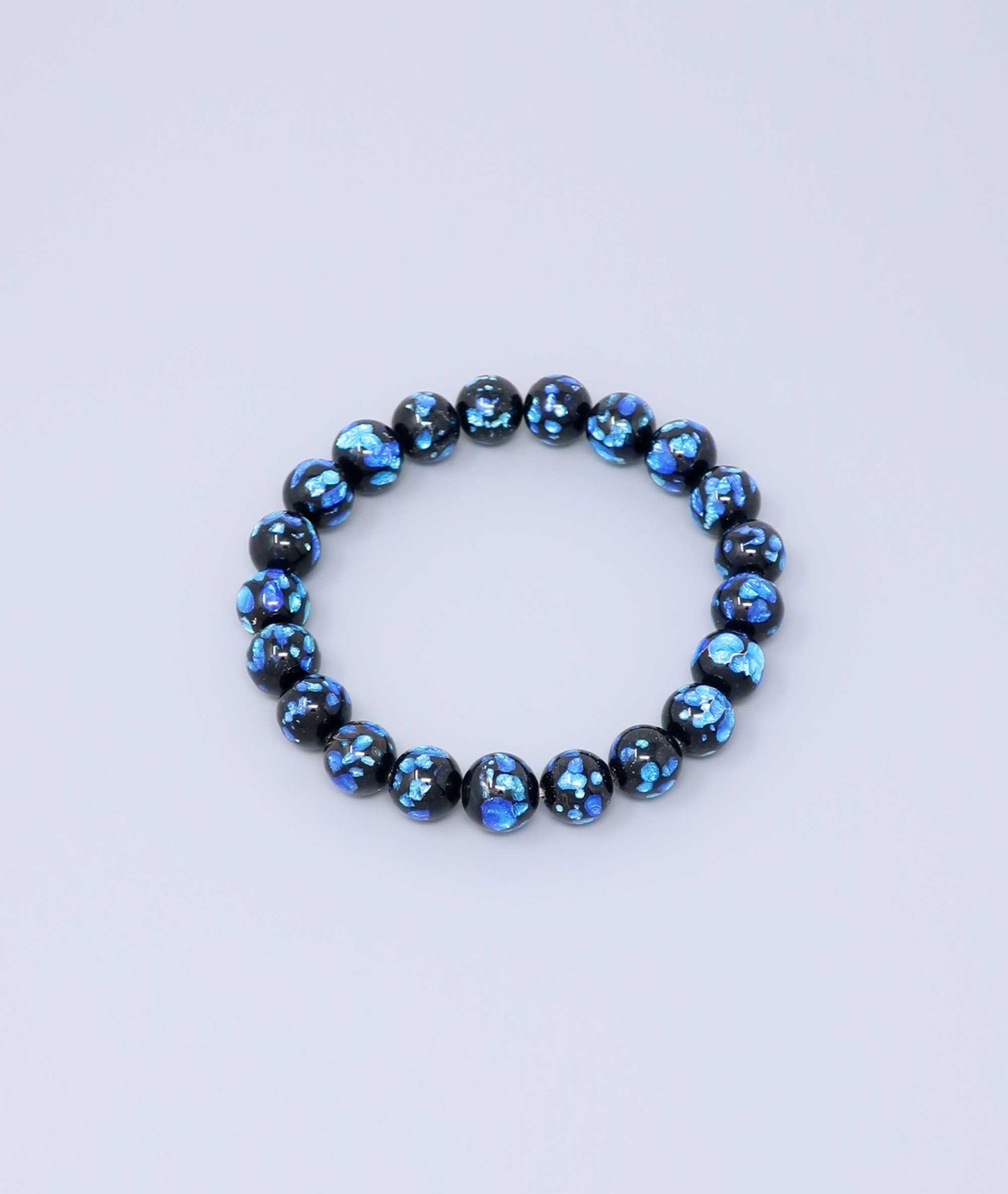 Elegant blue Ryukyu fluorite bracelet with shimmering light blue accents on a jet-black base. Handmade by artisans, combining mystique and luxury. Handcrafted in Japan Kanbe Juzu, ideal for amulet, yoga, meditation, prayer, or gifting.