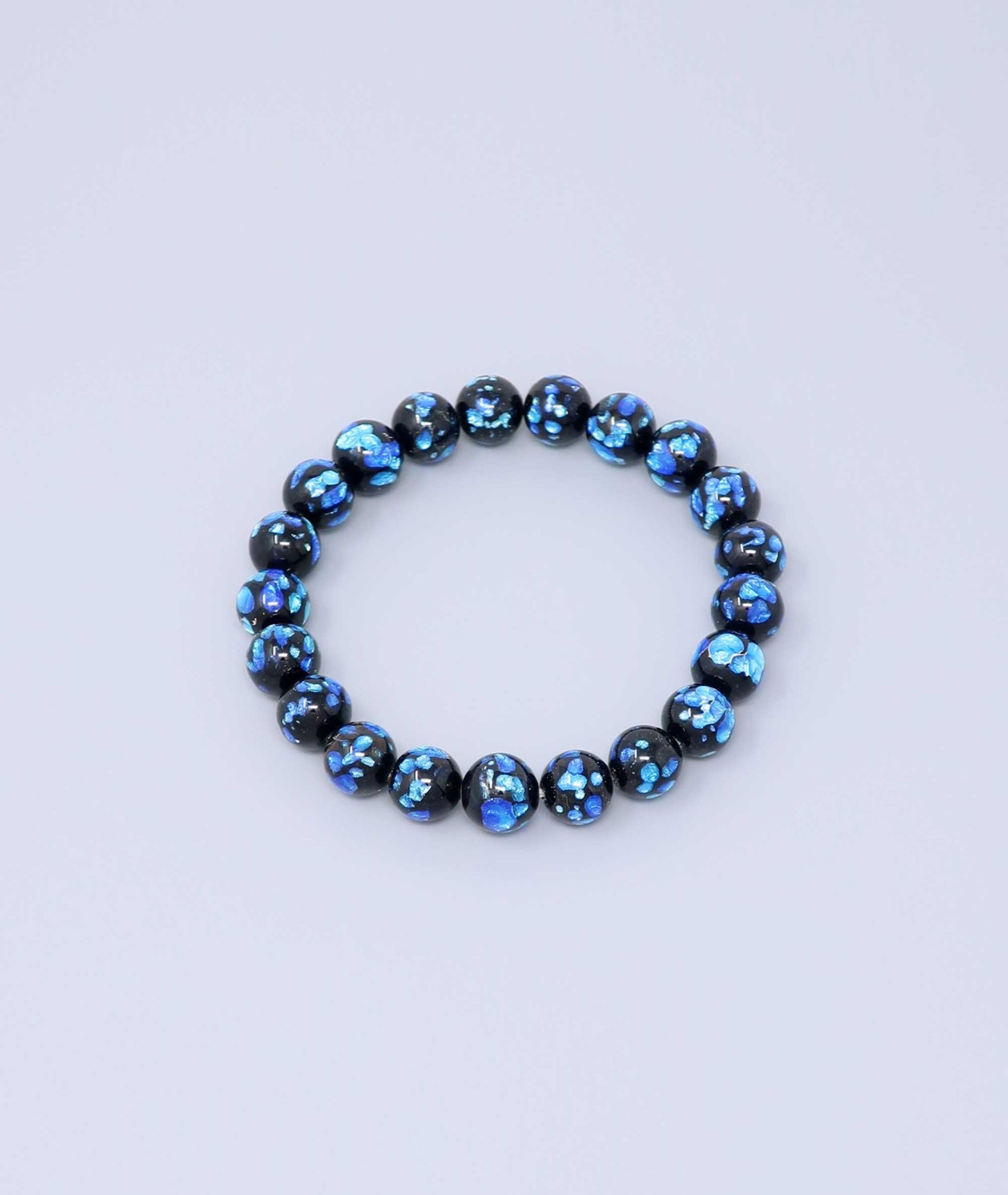Elegant blue Ryukyu fluorite bracelet with shimmering light blue accents on a jet-black base. Handmade by artisans, combining mystique and luxury. Handcrafted in Japan Kanbe Juzu, ideal for amulet, yoga, meditation, prayer, or gifting.