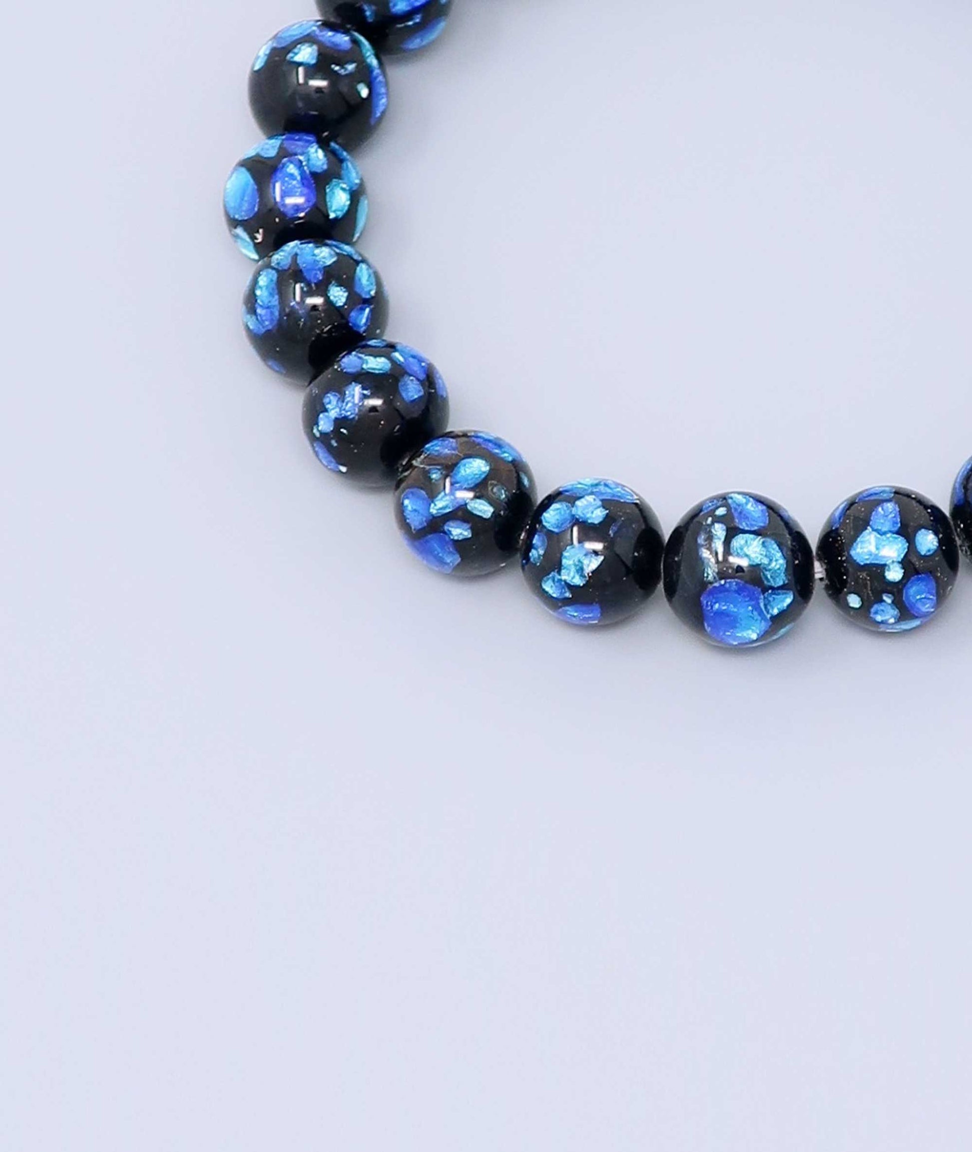 Elegant blue Ryukyu fluorite bracelet with shimmering light blue accents on a jet-black base. Handmade by artisans, combining mystique and luxury. Handcrafted in Japan Kanbe Juzu, ideal for amulet, yoga, meditation, prayer, or gifting.