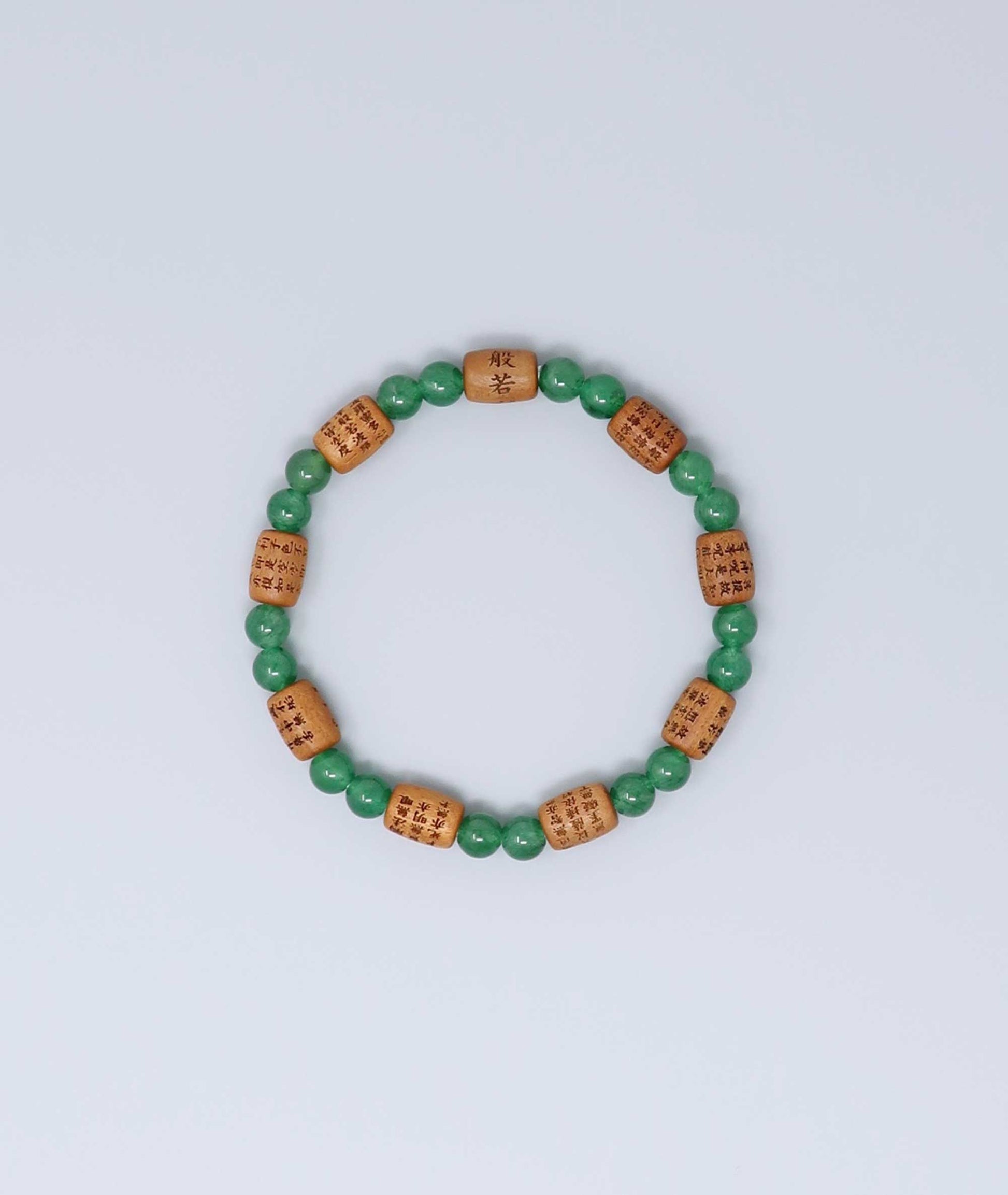 Sandalwood bracelet engraved with the Heart Sutra and accented with a jade bead—handcrafted for spiritual protection and harmony. Handcrafted in Kyoto Japan Kanbe Juzu