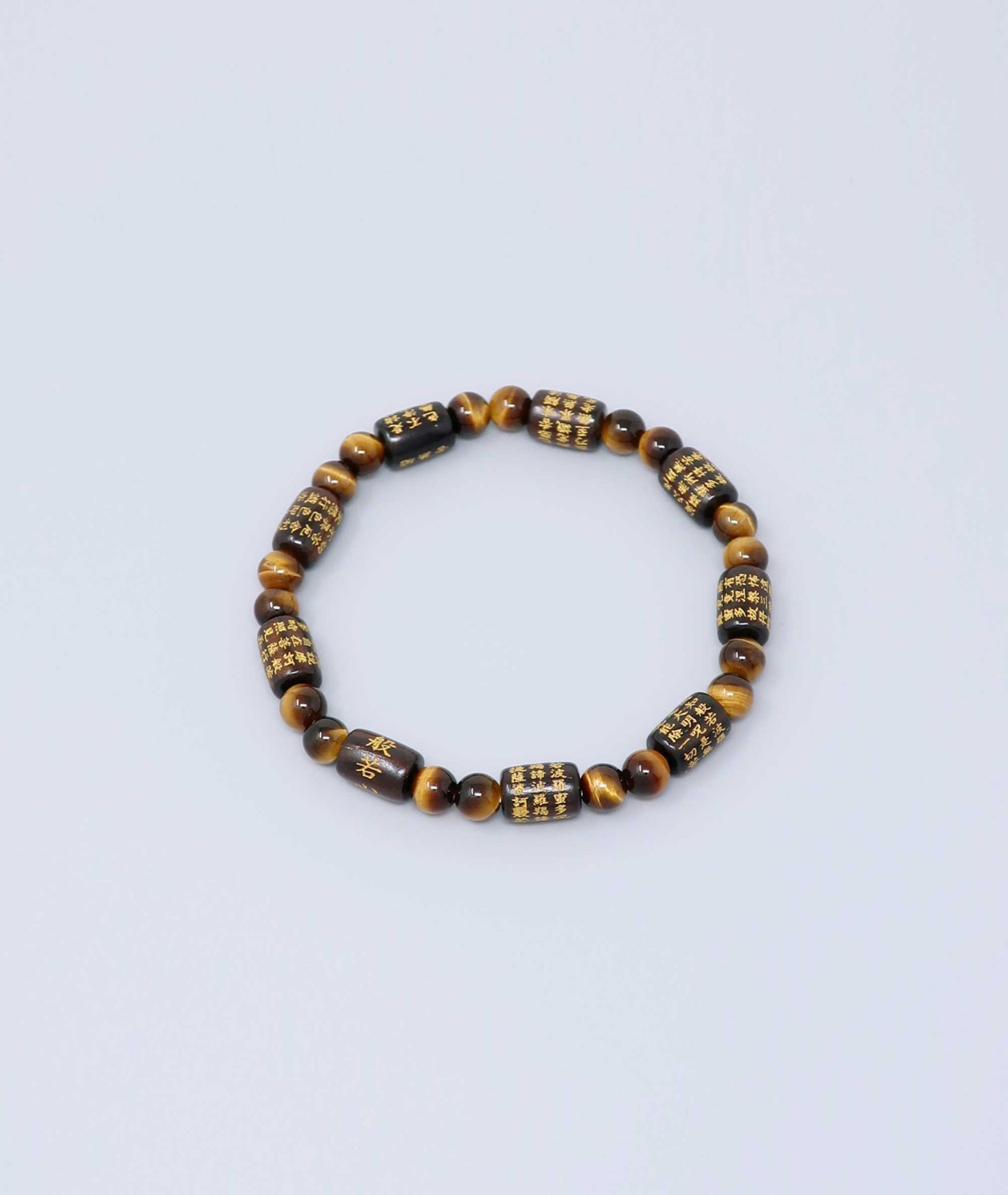 Striped ebony bracelet with Heart Sutra engraving and Tiger’s Eye beads, handmade for spiritual protection and strength. Handcrafted in Kyoto Japan Kanbe Juzu