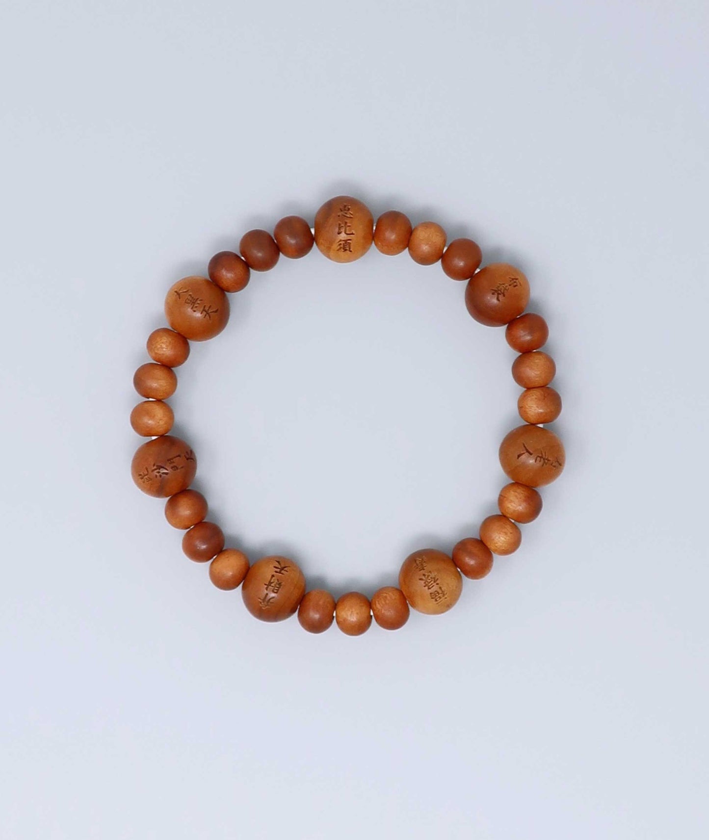 Sandalwood prayer beads mala bracelet with carvings of Japan’s Seven Lucky Gods, known for a calming scent and spiritual symbolism. Handcrafted in Japan Kanbe Juzu, ideal for amulet, yoga, meditation, prayer, or gifting.