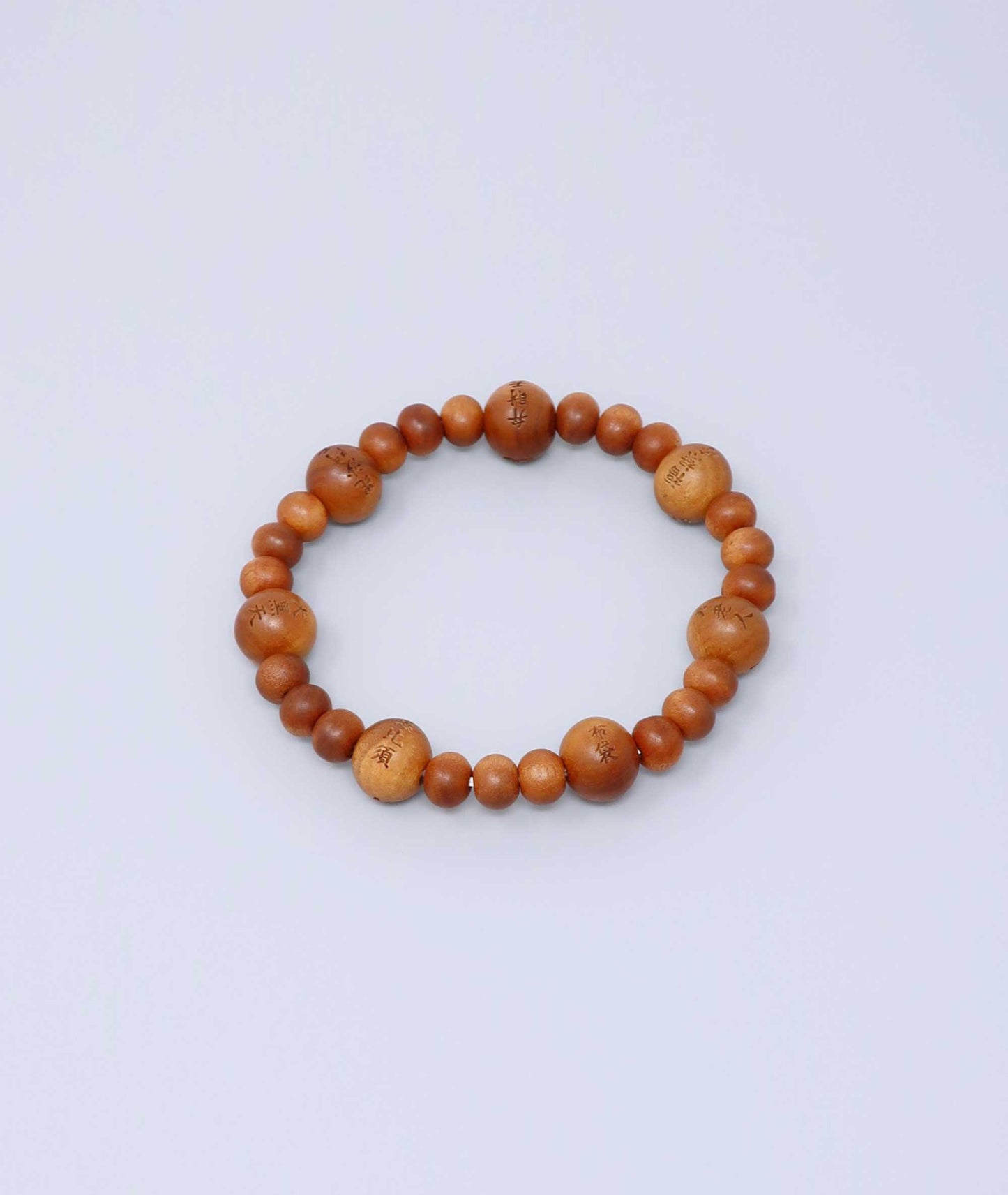 Sandalwood prayer beads mala bracelet with carvings of Japan’s Seven Lucky Gods, known for a calming scent and spiritual symbolism. Handcrafted in Japan Kanbe Juzu, ideal for amulet, yoga, meditation, prayer, or gifting.