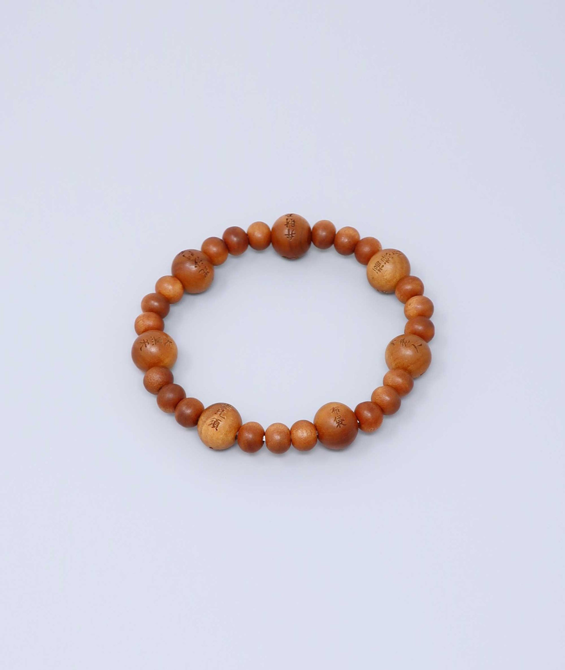 Sandalwood prayer beads mala bracelet with carvings of Japan’s Seven Lucky Gods, known for a calming scent and spiritual symbolism. Handcrafted in Japan Kanbe Juzu, ideal for amulet, yoga, meditation, prayer, or gifting.