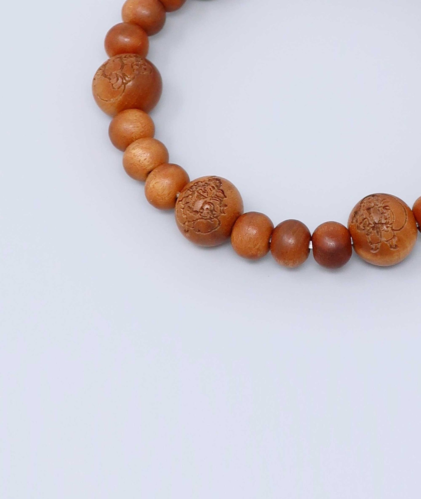 Sandalwood prayer beads mala bracelet with carvings of Japan’s Seven Lucky Gods, known for a calming scent and spiritual symbolism. Handcrafted in Japan Kanbe Juzu, ideal for amulet, yoga, meditation, prayer, or gifting.