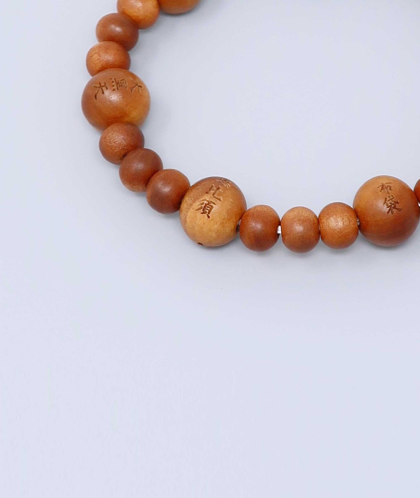 Sandalwood prayer beads mala bracelet with carvings of Japan’s Seven Lucky Gods, known for a calming scent and spiritual symbolism. Handcrafted in Japan Kanbe Juzu, ideal for amulet, yoga, meditation, prayer, or gifting.