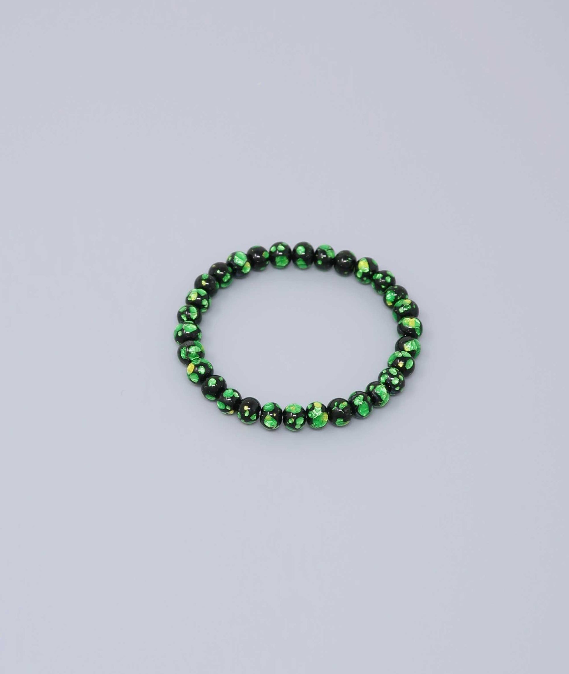 Elegant green Ryukyu fluorite bracelet with shimmering green accents on a jet-black base. Handmade by artisans, combining mystique and luxury. Handcrafted in Japan Kanbe Juzu, ideal for amulet, yoga, meditation, prayer, or gifting.