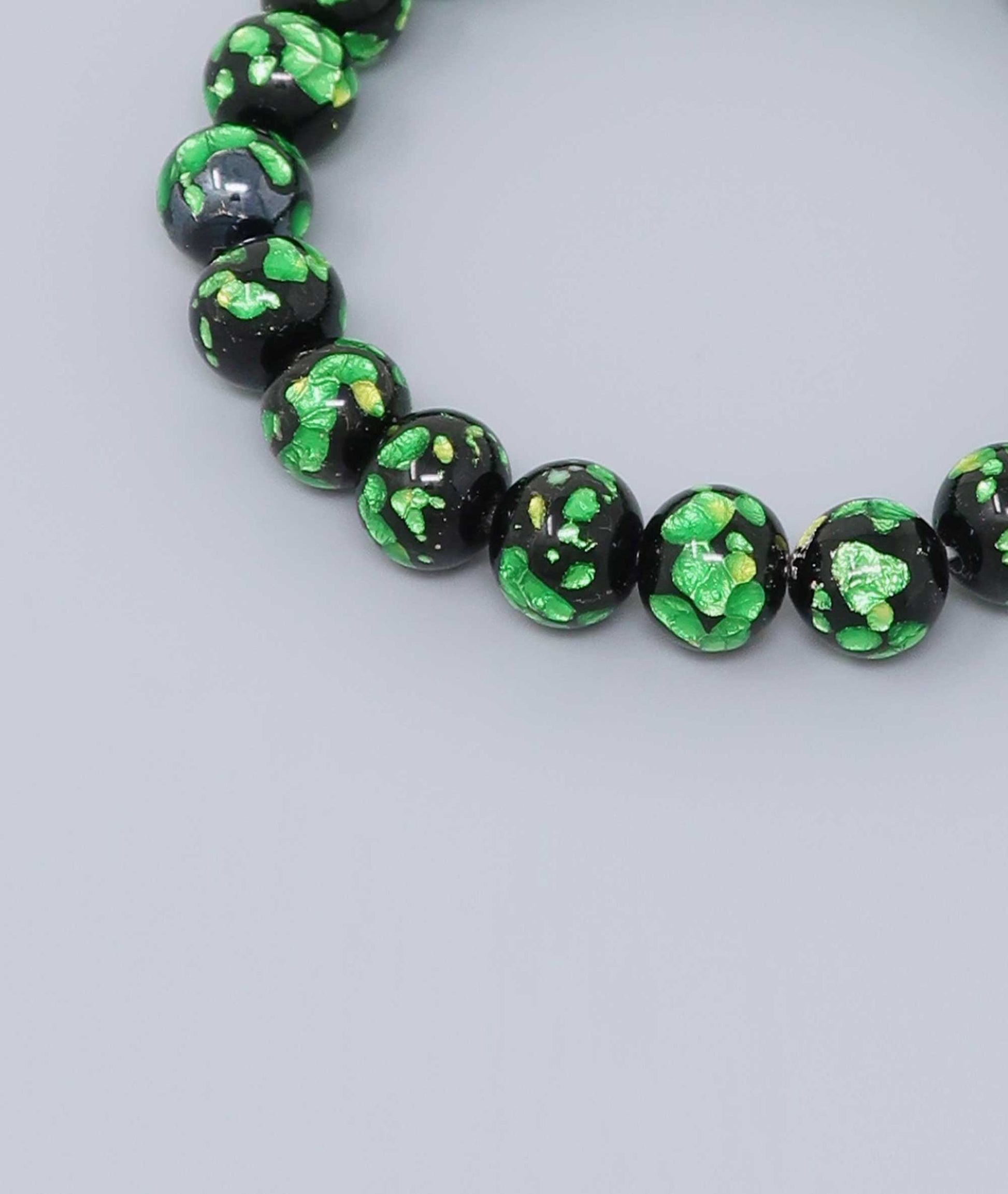 Elegant green Ryukyu fluorite prayer bead mala bracelet with shimmering green accents on a jet-black base. Handmade by artisans, combining mystique and luxury. Handcrafted in Japan Kanbe Juzu, ideal for amulet, yoga, meditation, prayer, or gifting.